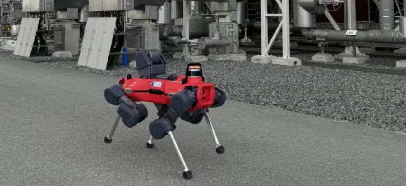 A four-legged inspection robot patrolling an industrial energy facility